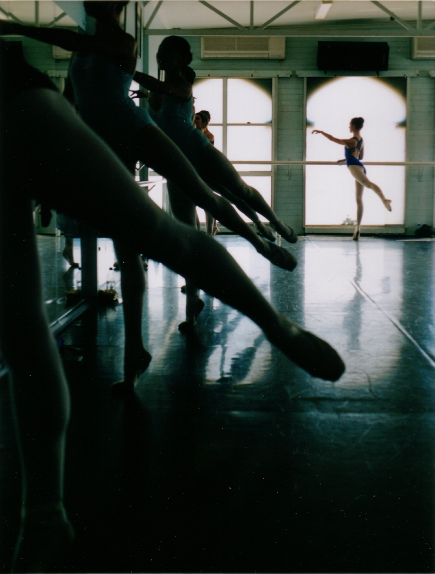stretched legs of several ballet dancers